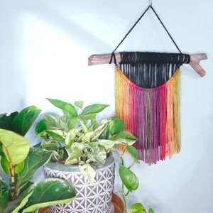 Handmade yarn wall hanging on driftwood